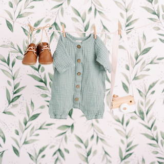 Baby onesie and shoes hanging on a line Easter bunny ornament on a table | Vancouver Gift Baskets for Newborn & Baby