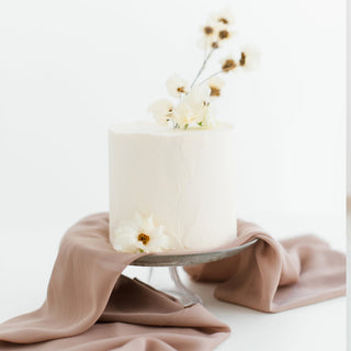 White wedding cake with flowers Easter bunny ornament on a table | Vancouver Gift Baskets for Weddings & Anniversaries