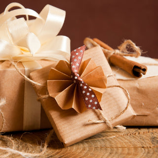 Gifts wrapped in brown paper and bows Easter bunny ornament on a table | Vancouver Gift Baskets for Him