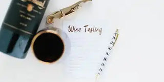 Wine bottle, glass, and notebook with 'Wine Tasting' text on a white background