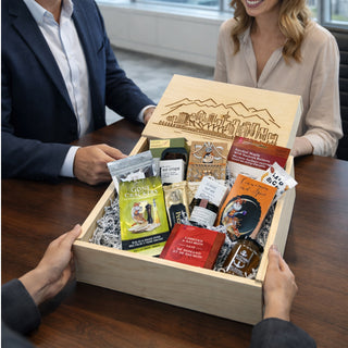 Gift box with various items being handed over to a person at a table.